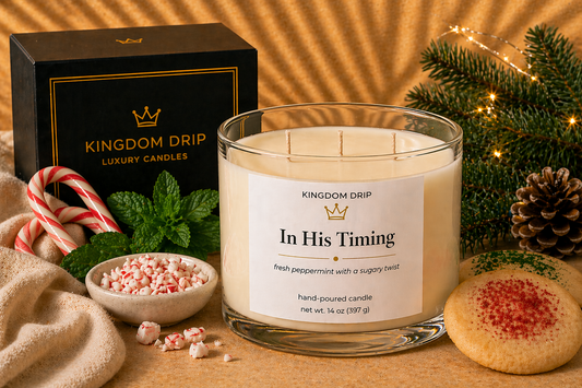Kingdom Drip candle with festive decorations on a wooden surface